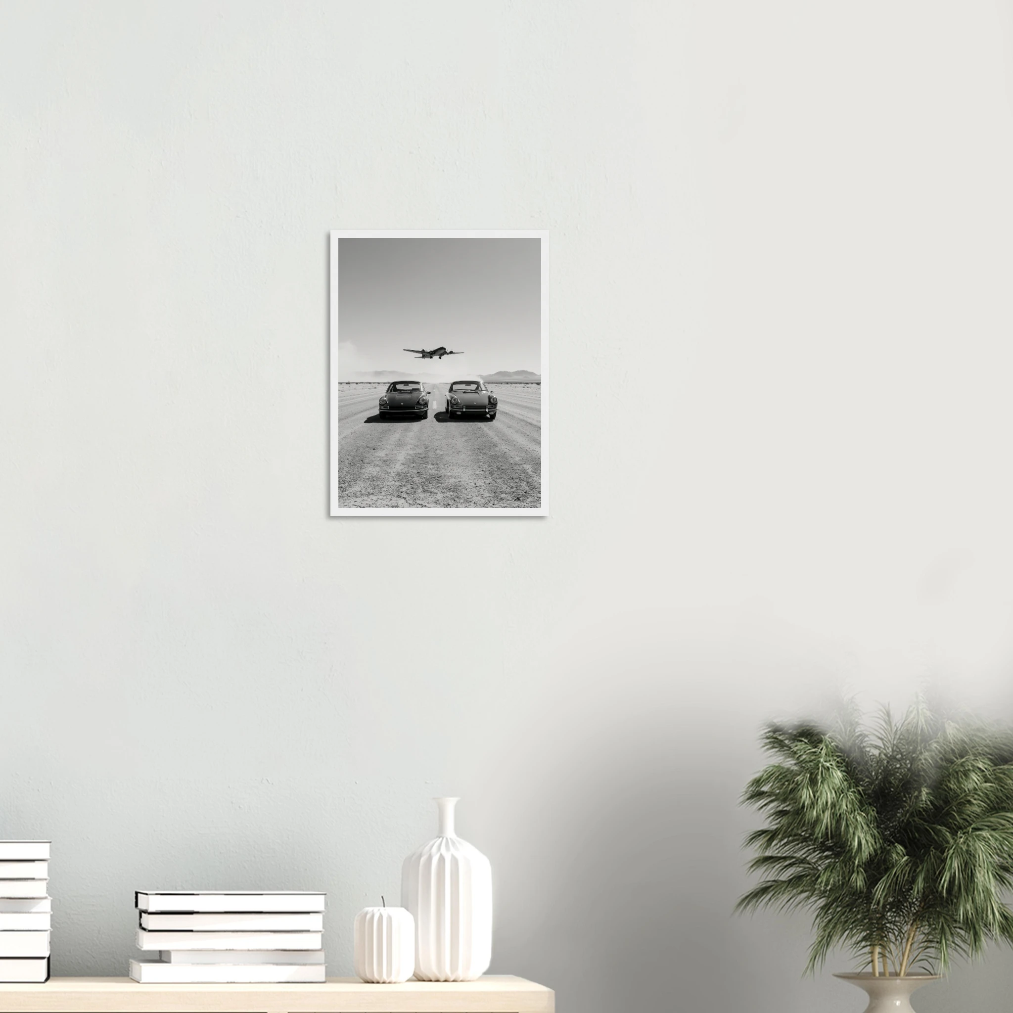 Porsche 911 and WW2 planes framed print hanging above a sofa as vintage aviation wall art
